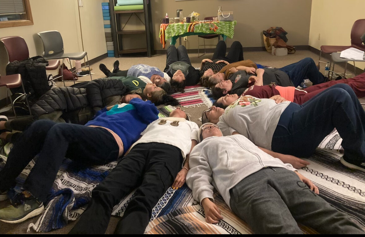 Safehouse Progressive Alliance for Nonviolence, Inc. (SPAN) in Boulder, Colorado 13 people lie on their backs on the floor in a circle.