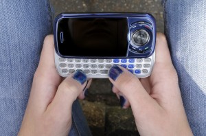 teen girl hands nailpolish cellphone